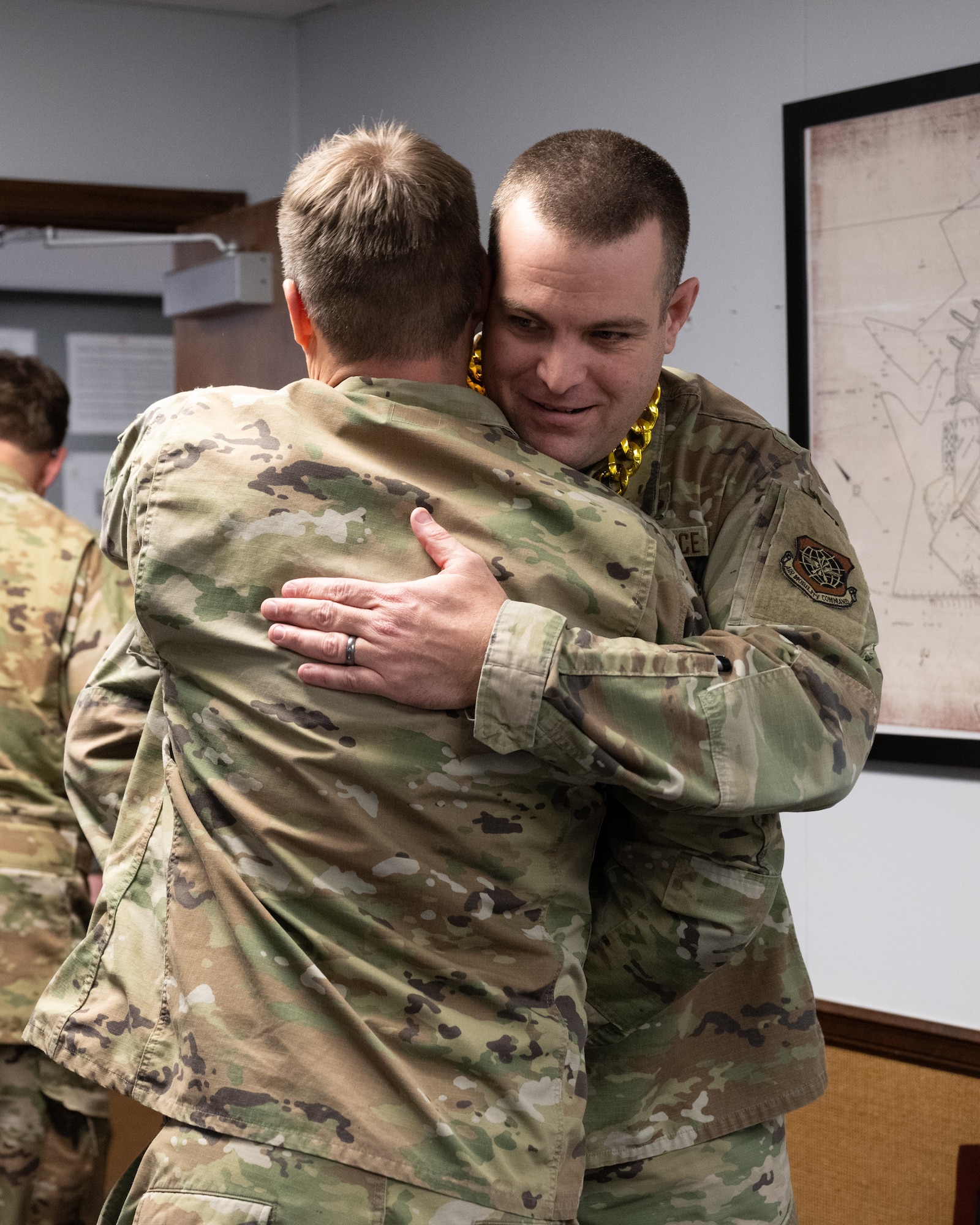 U.S. Air Force Senior Master Sgt. Adam Crothers, 436th Maintenance Squadron maintenance superintendent, is congratulated after being notified of his selection for promotion to the rank of Chief Master Sgt. at Dover Air Force Base, Delaware, Jan. 6, 2026. After being notified by their leadership and members of the Dover Chiefs’ Council, each selectee joins the group and travels with them to notify the next selectee on the list. (U.S. Air Force photo by Mauricio Campino)