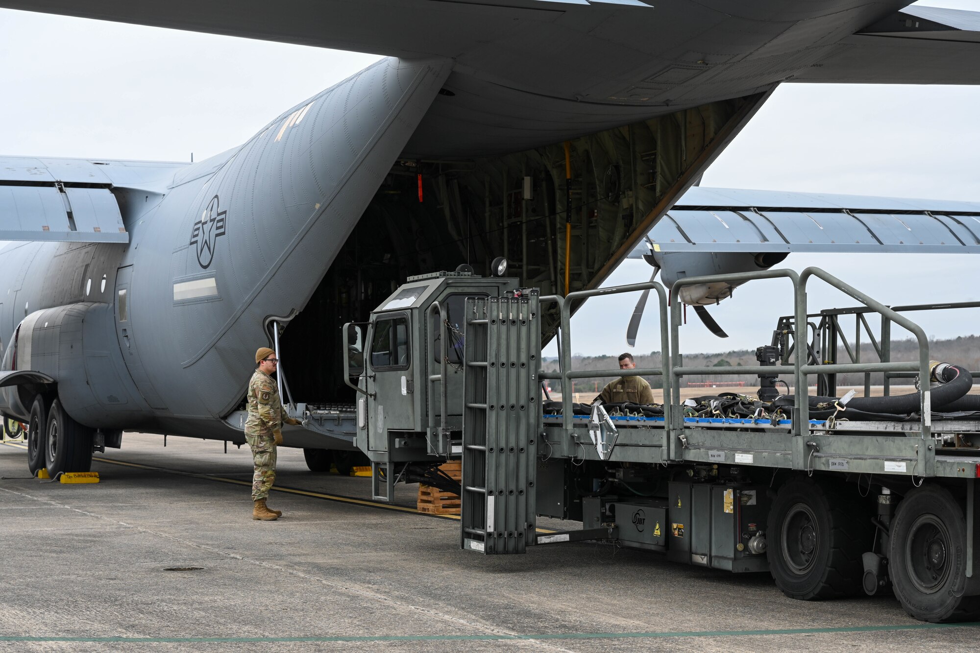 Airmen load a fuel system onto an aircraft.