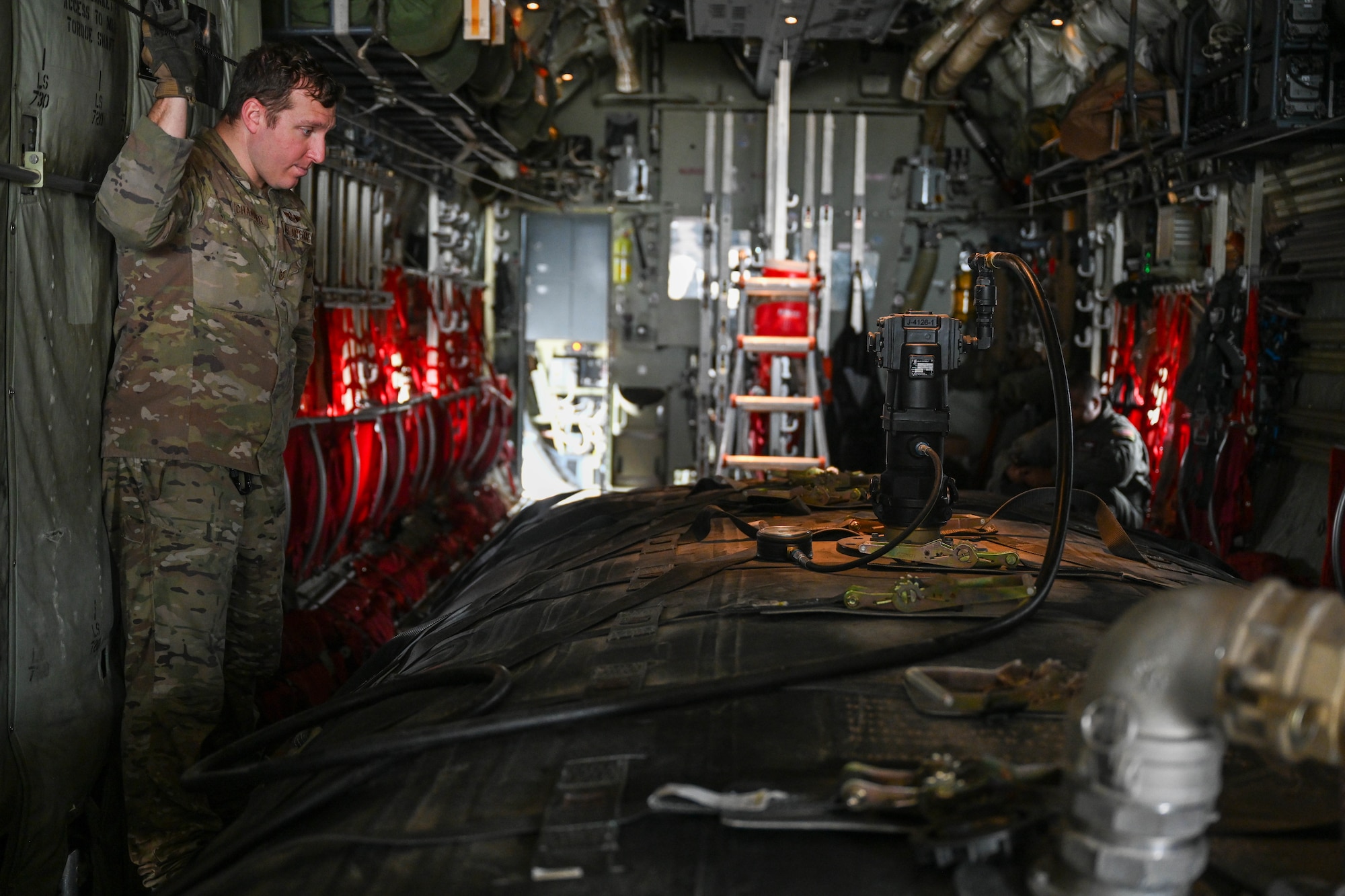 An Airman looks at a gauge.