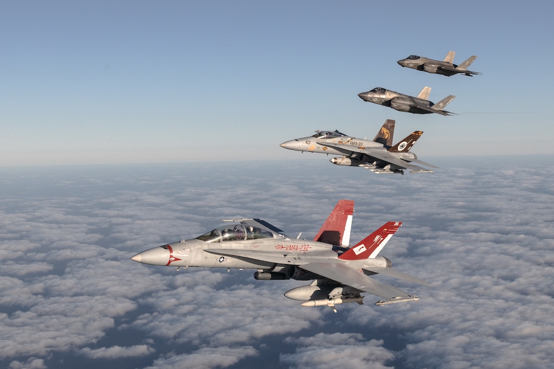 U.S. Marines and aircraft with Marine Aircraft Group 11, 3rd Marine Aircraft Wing, conduct a formation flight as part of Project Legacy off the coast of San Diego, March 4, 2025. The Project Legacy flight was a unique opportunity for all aircraft platforms across MAG-11 to fly as one team, practice tight formations, and take part in the documentation of a historical flight. (U.S. Marine Corps photo by Lance Cpl. Jennifer Sanchez)
