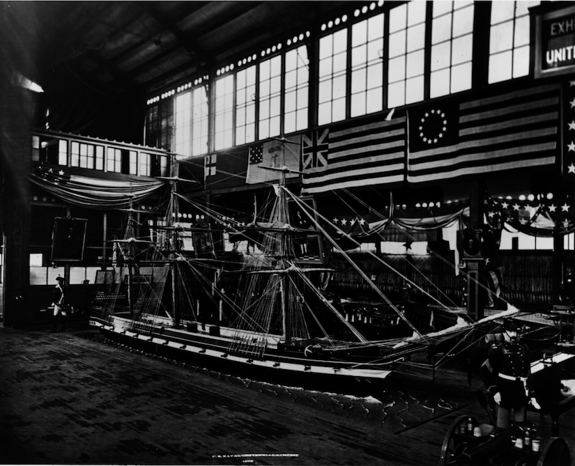A model of a sailing ship is shown in a warehouse.