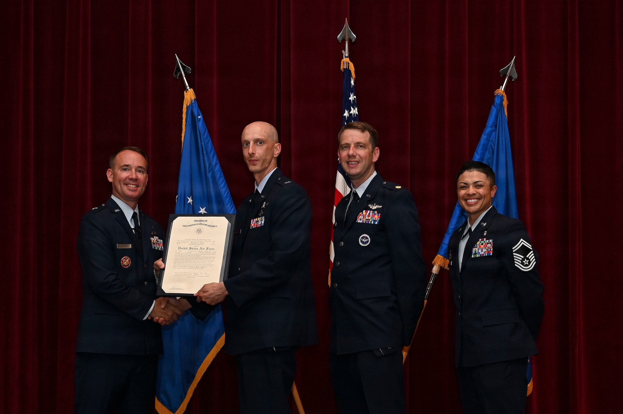 U.S. Air Force Brig. Gen. Reid J. Novotny, Director of Intelligence & Cyber Effects Operations, National Guard Bureau, presents a graduation certificate to Chief Warrant Officer 2 Benjamin Koloff, capabilities developer and cyberspace operator for the 175th Cyberspace Operations Squadron, during the Warrant Officer Training School graduation for Class 25-04 at Maxwell Air Force Base, Alabama, July 31, 2025. Koloff was the recipient of the Top Graduate award of class 25-04 and Outstanding Contributor for Long Flight. (Courtesy Photo)