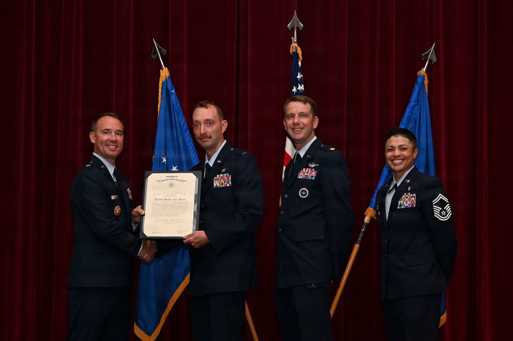 U.S. Air Force Brig. Gen. Reid J. Novotny, Director of Intelligence & Cyber Effects Operations, National Guard Bureau, presents a graduation certificate to Warrant Officer Allen Ramsay, cyber analyst for the 175th Cyberspace Operations Squadron, during the Warrant Officer Training School graduation for Class 25-04 at Maxwell Air Force Base, Alabama, July 31, 2025. The training for each class spanned over an eight-week timeframe, which focused on the main tenets of a warrant officer, which include professional warfighting, technical integrating, and credible advising. (Courtesy Photo)