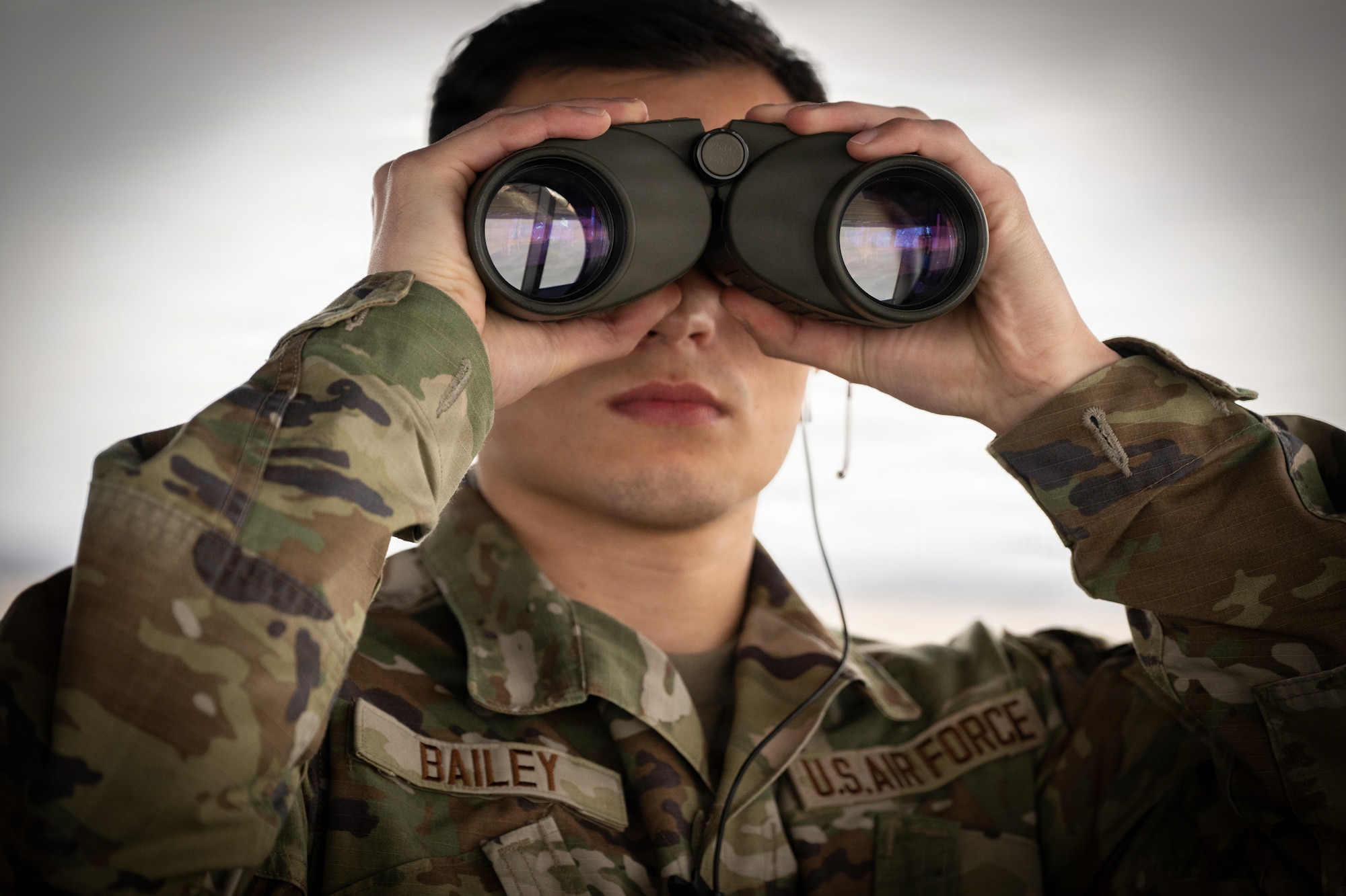 U.S. Airman Jordan Bailey, 436th Operational Support Squadron Air Traffic Control tower apprentice, looks out for approaching aircraft at Dover Air Force Base, Delaware, Dec. 29, 2025. Tower controllers manage aircraft and vehicle movement on the ground and in the immediate airspace surrounding the installation out to 4.9 nautical miles and up to 2,500 feet.