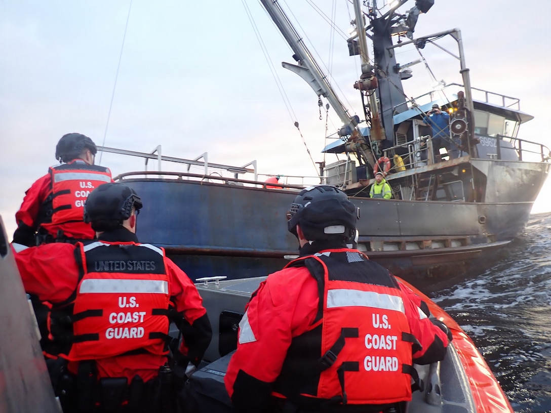 Three U.S. Coast Guard boarding team members from USCGC Kimball (WMSL 756) prepare to board the fishing vessel Caravelle just outside Dutch Harbor, Alaska, Oct. 1, 2025. The team was deployed from the bow of a 35-foot Long Range Interceptor II to conduct routine fisheries law enforcement operations and ensure compliance with federal regulations. (U.S. Coast Guard photo by Petty Officer 1st Class Michael Maust)