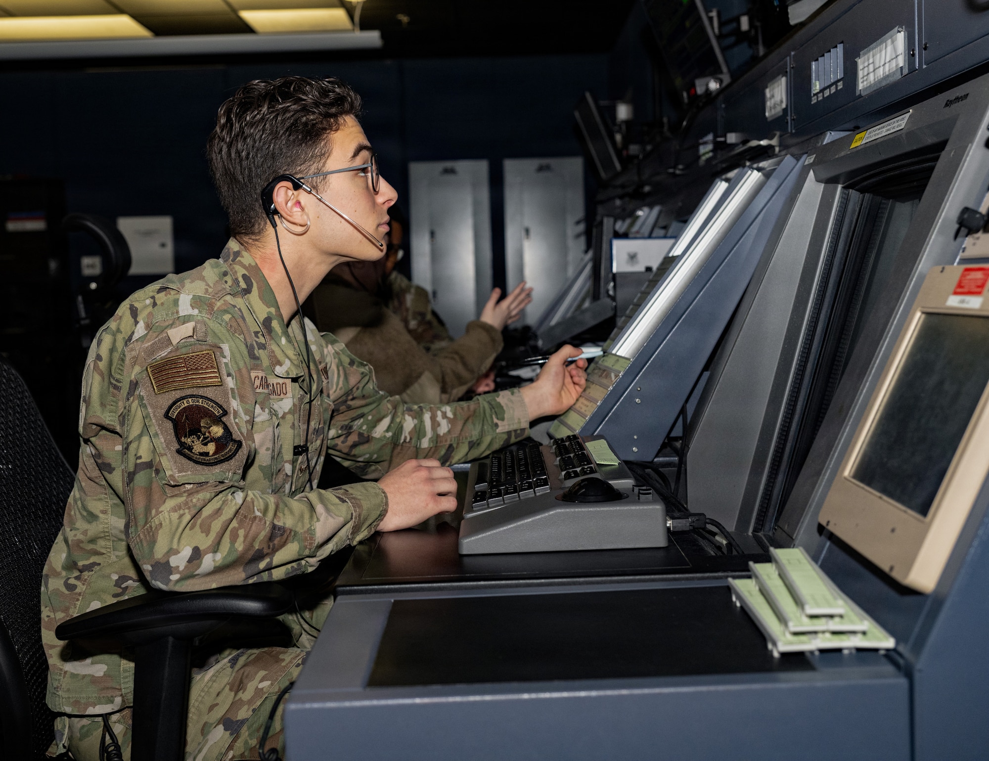U.S. Airman 1st Class Roberto Cabrera Delgado, 436th Operational Support Squadron Air Traffic Control radar approach control specialist, views a display screen showing aircraft in the surrounding airspace on Dover Air Force Base, Delaware, Dec. 29, 2025.  RAPCON Airmen are responsible for guiding aircraft within Dover AFB airspace that are outside the 4.9 nautical mile range of the Air Traffic Control Tower.