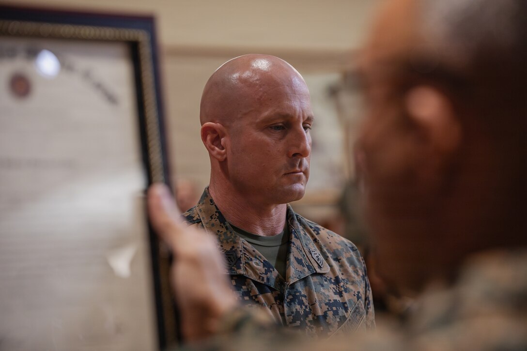 U.S. Marine Corps Sgt. Maj. Edwin A. Mota, command senior enlisted leader of Marine Forces Reserve and Marine Forces South, reads a redesignation warrant during a redesignation ceremony for 1st Sgt. Joseph B. Stoker, an individual material readiness list coordinator with 4th Marine Aircraft Wing, at Marine Corps Support Facility, New Orleans, Jan. 7, 2025. Stoker became one of the first Marines to laterally transfer to first sergeant through the E-8 redesignation board pilot, a new program within the Marine Corps that allows qualified master sergeants to apply for redesignation as first sergeants. (U.S. Marine Corps photo by Lance Cpl. Van Hoang)
