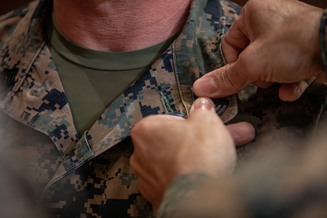 U.S. Marine Corps Sgt. Maj. Edwin A. Mota, command senior enlisted leader of Marine Forces Reserve and Marine Forces South, pins first sergeant ranks onto 1st Sgt. Joseph B. Stoker, an individual material readiness list coordinator with 4th Marine Aircraft Wing, at Marine Corps Support Facility, New Orleans, Jan. 7, 2025. Stoker became one of the first Marines to laterally transfer to first sergeant through the E-8 redesignation board pilot, a new program within the Marine Corps that allows qualified master sergeants to apply for redesignation as first sergeants. (U.S. Marine Corps photo by Lance Cpl. Van Hoang)