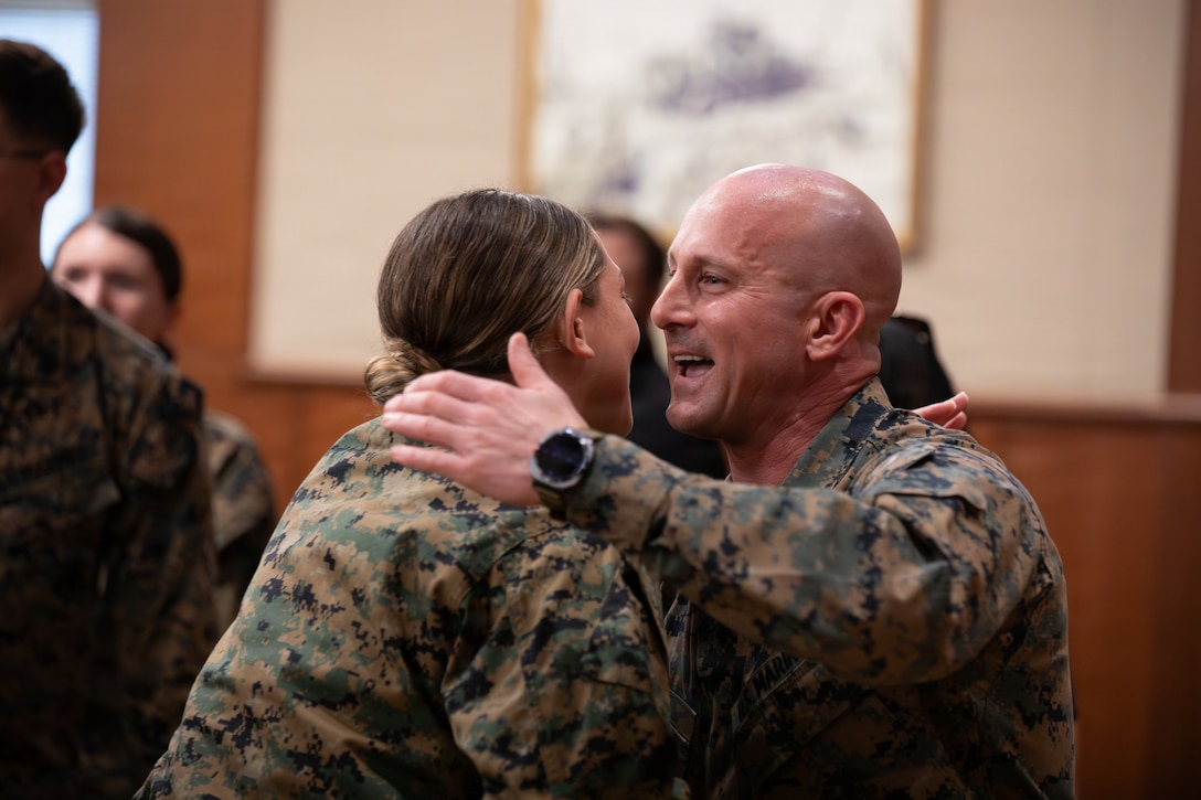 U.S. Marine Corps 1st Lt. Quiarra Barros, left, communication strategy and operations officer with Marine Forces Reserve, congratulates 1st Sgt. Joseph B. Stoker, an individual material readiness list coordinator with 4th Marine Aircraft Wing, during a promotion ceremony, Marine Corps Support Facility, New Orleans, Jan. 7, 2025. Stoker became one of the first Marines to laterally transfer to first sergeant through the E-8 redesignation board pilot, a new program within the Marine Corps that allows qualified master sergeants to apply for redesignation as first sergeants. (U.S. Marine Corps photo by Lance Cpl. Van Hoang)