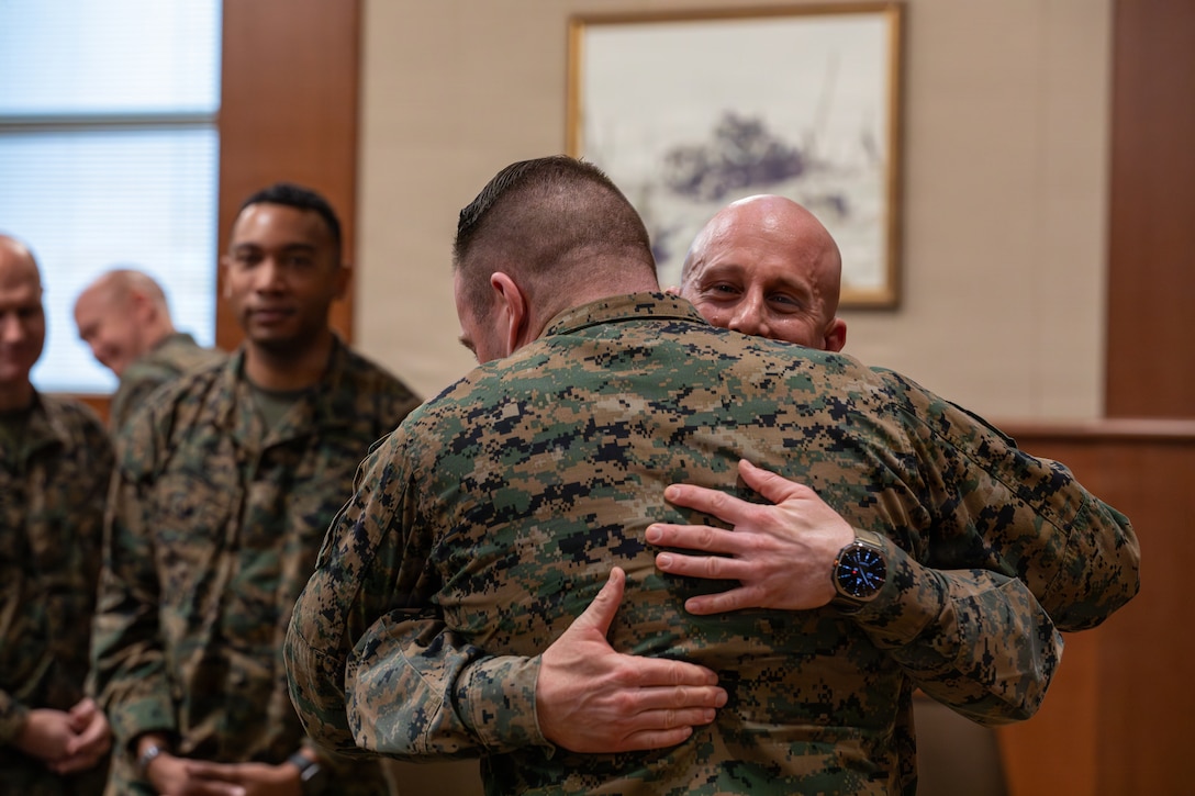 U.S. Marines congratulate 1st Sgt. Joseph B. Stoker, an individual material readiness list coordinator with 4th Marine Aircraft Wing, during a promotion ceremony, Marine Corps Support Facility, New Orleans, Jan. 7, 2025. Stoker became one of the first Marines to laterally transfer to first sergeant through the E-8 redesignation board pilot, a new program within the Marine Corps that allows qualified master sergeants to apply for redesignation as first sergeants. (U.S. Marine Corps photo by Lance Cpl. Van Hoang)