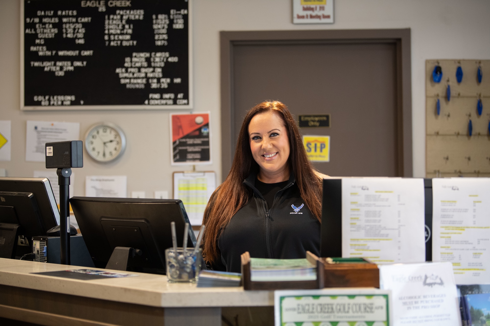 Leslie Estabrook, 436th Force Support Squadron recreation aide, poses for a photo behind the counter at Eagle Creek Golf Course on Dover Air Force Base, Delaware, Oct. 18, 2025. Leslie’s family originally lived on the course before it was bought by the U.S. military. (U.S. Air Force photo by Airman 1st Class Liberty Kuhn)