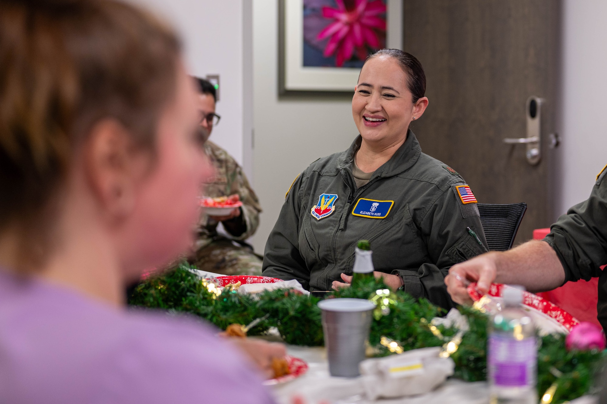 U.S. Air Force Maj. Elizabeth Kuss, 325th Operational Medical Readiness Squadron flight medicine flight commander, laughs with her team during a holiday potluck at Tyndall Air Force Base.