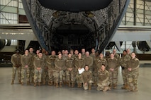 A photo of Airmen standing in front of a C-17 Globemaster III.