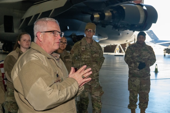 A photo of Lt. Col Richard Holmes addressing a group of Airmen.