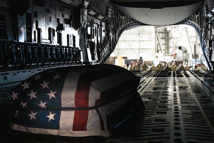 A photo of an empty casket sitting inside of a C-17 Globemaster III.