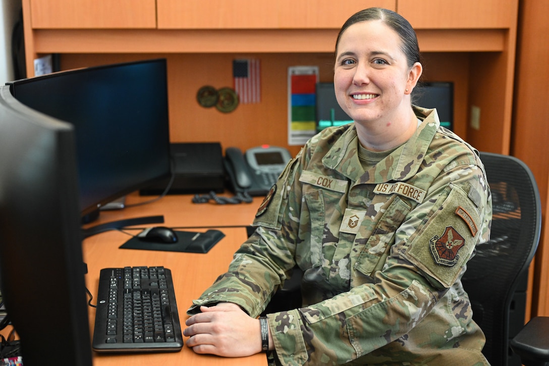 U.S. Air Force Master Sgt. Sydney Cox, 28th Force Support Squadron career development advisor, poses for a photo at her desk at Ellsworth Air Force Base, S.D., Nov. 20, 2025.