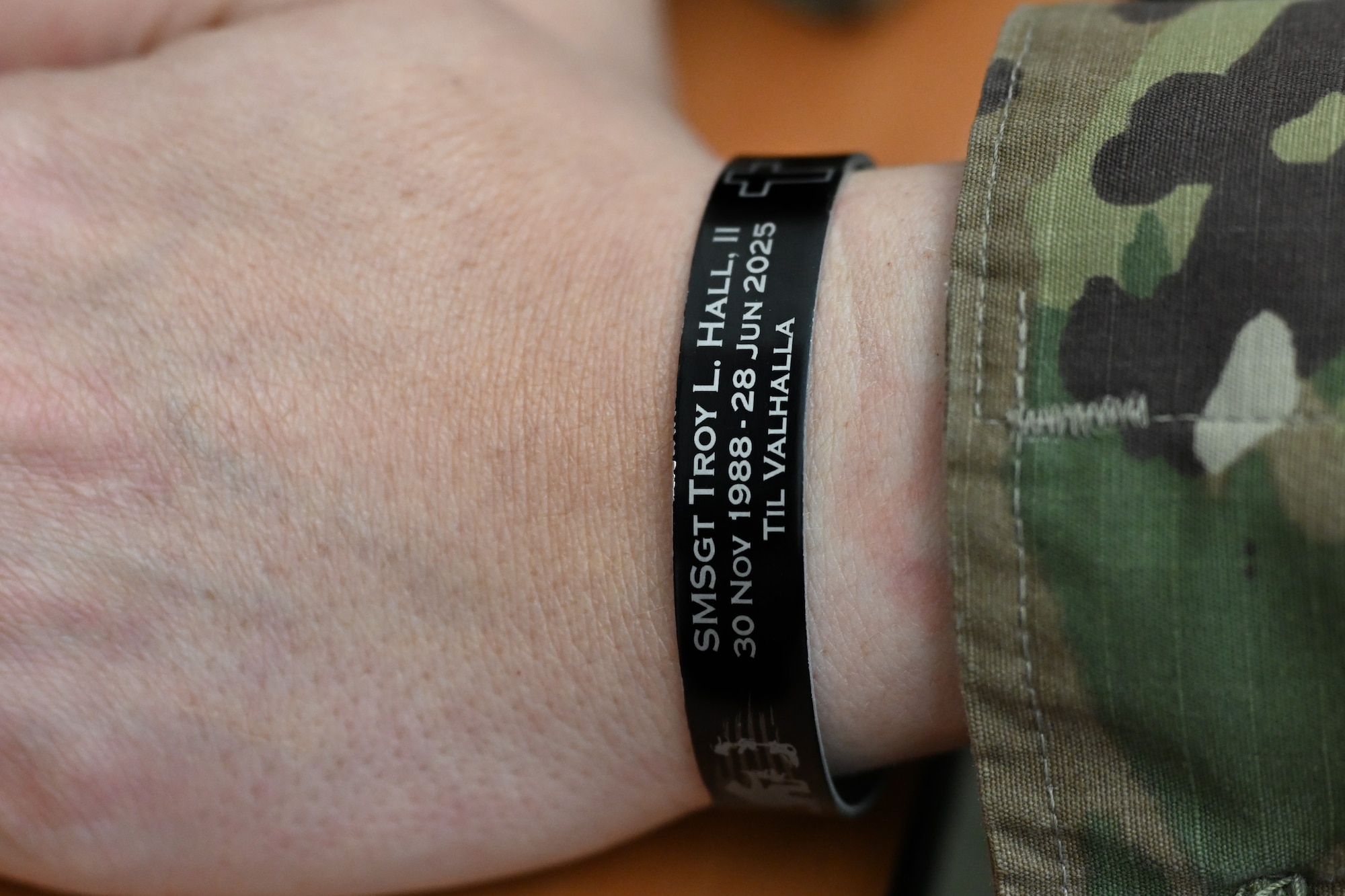 U.S. Air Force Master Sgt. Sydney Cox, 28th Force Support Squadron career development advisor, wears an honor bracelet at Ellsworth Air Force Base, S.D., Nov. 20, 2025.