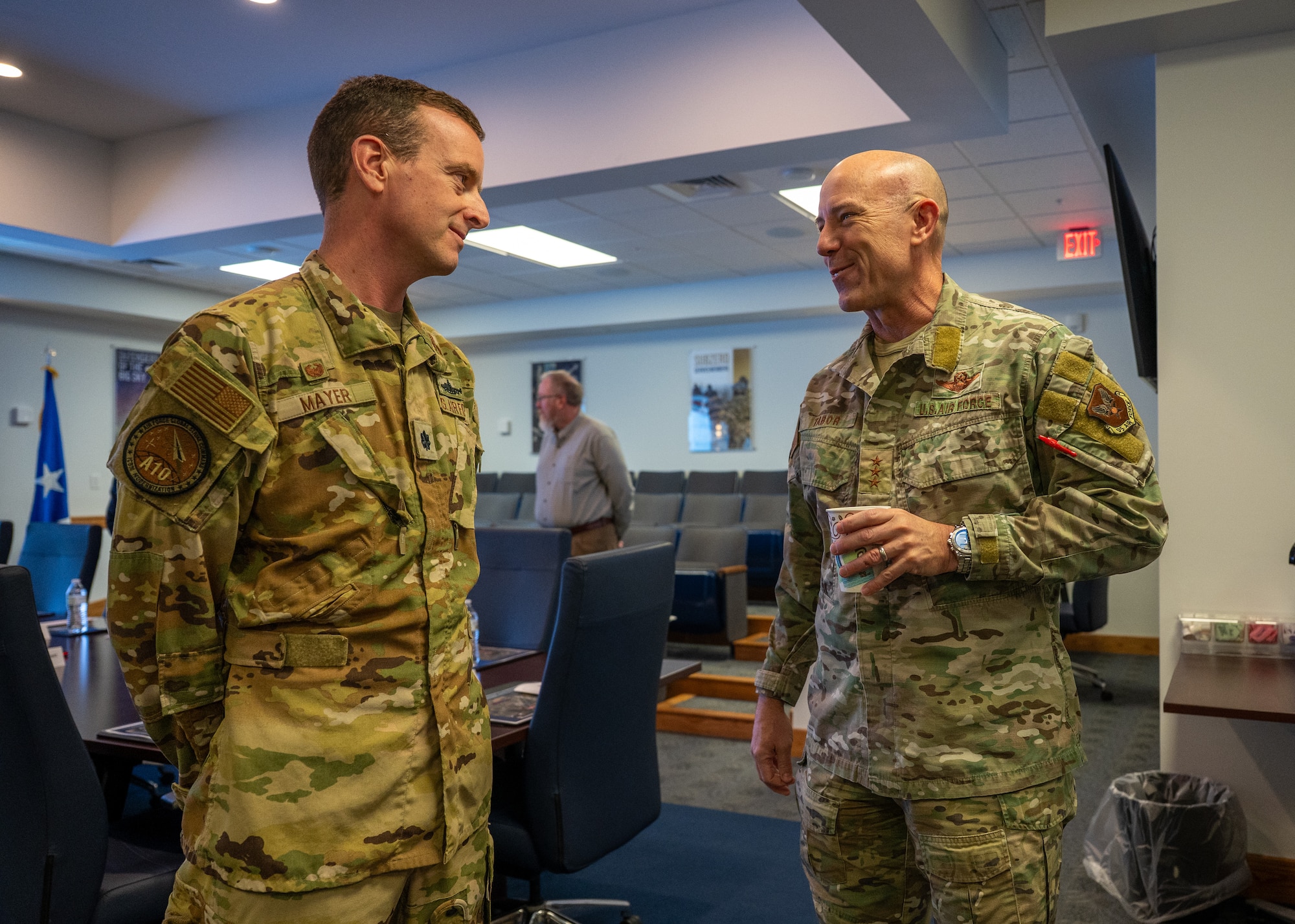 Two uniformed personnel converse with one another.