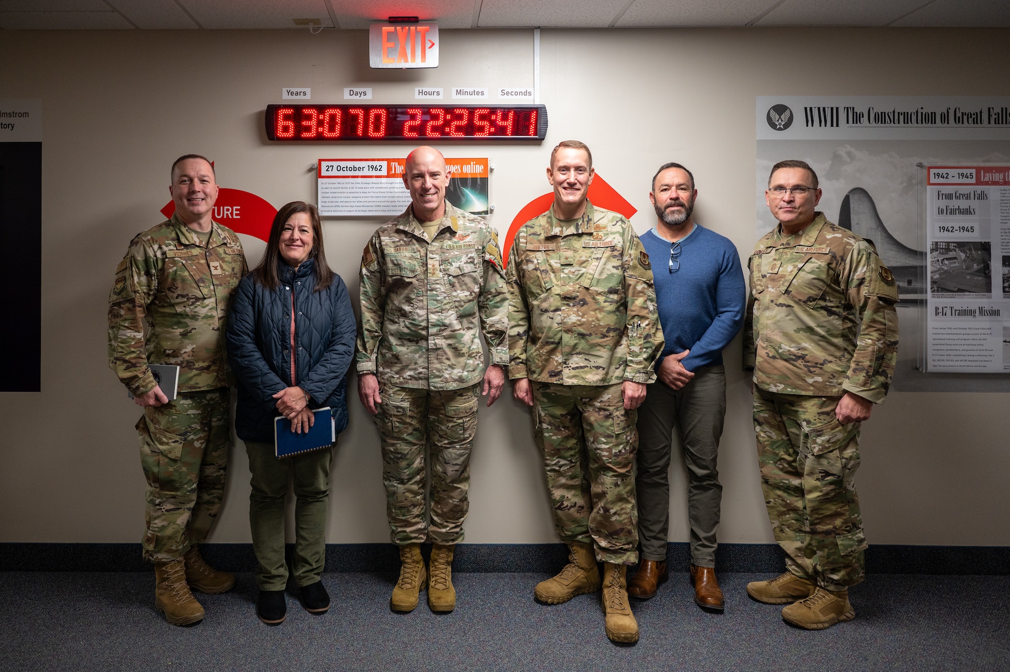 Five people pose for a photo