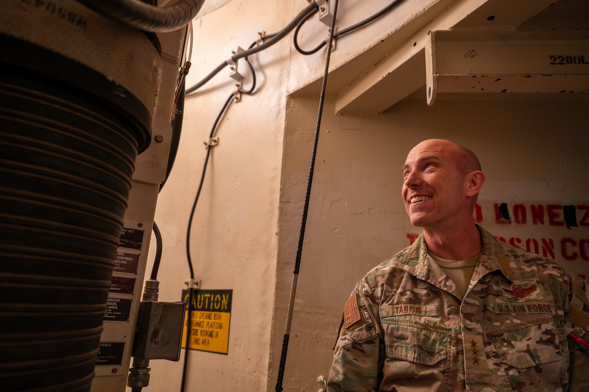 Uniformed personnel smiles in a launch facility