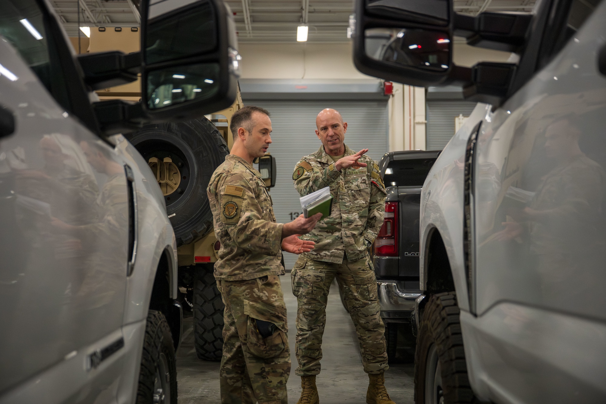 Two uniformed personnel converse with one another.