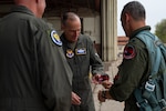 Lt. Col. Michael “Hyde” Trott, commander of the 99th Flying Training Squadron, hands a T-7A patch to Lt. Gen. Scott L. Pleus, Acting Vice Chief of Staff of the United States Air Force to celebrate the aircraft transfer to the 99th FTS during the arrival ceremony at Joint Base San Antonio-Randolph, Texas, Jan. 9, 2026. The arrival of the T-7A Red Hawk marks a historic milestone for Air Education and Training Command as it replaces the six-decade-old T-38 Talon, advancing pilot training for the U.S. Air Force. (U.S. Air Force photo by Zelideth Rodriguez)