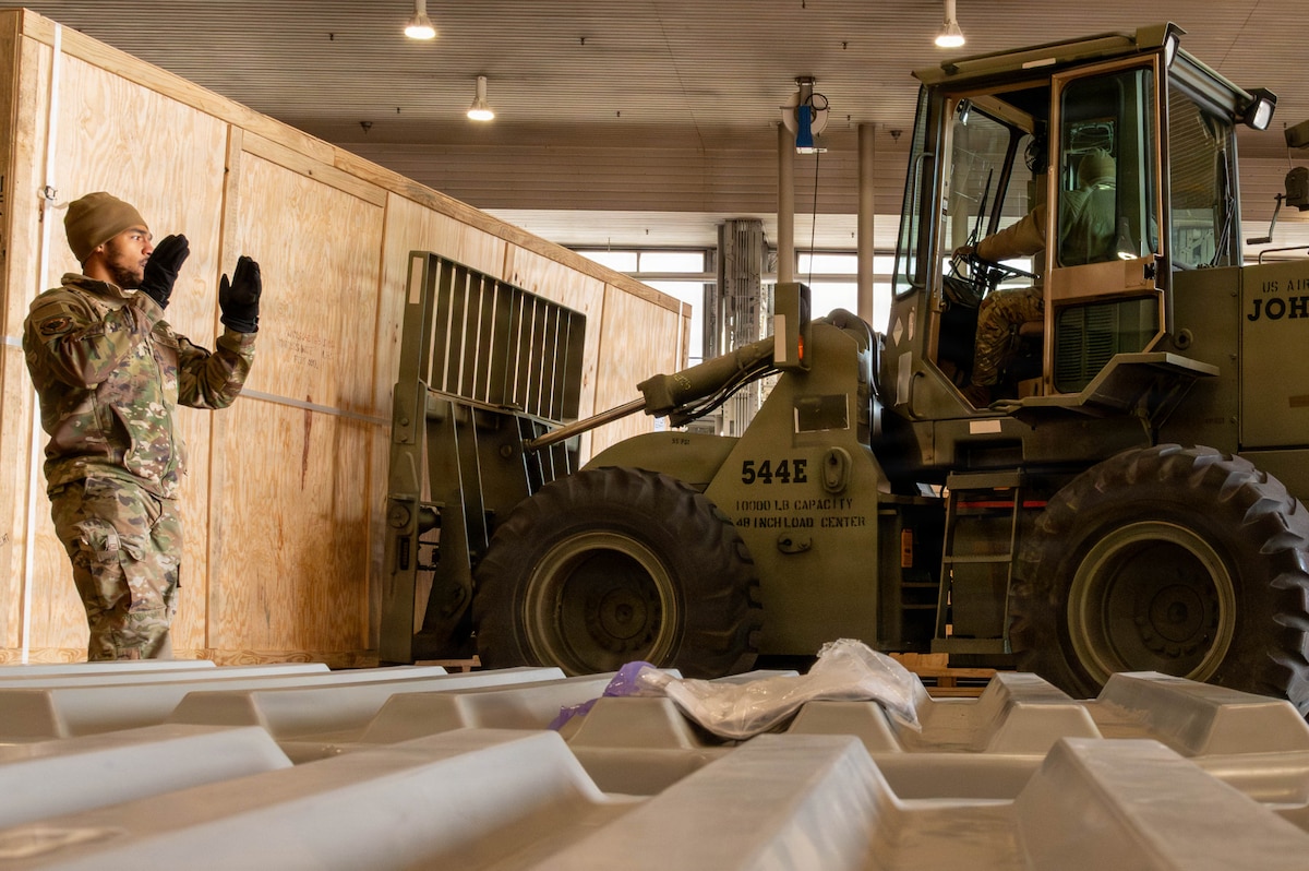 U.S. Air Force Airman 1st Class Zyire Quarles, 14th Fighter Generation Squadron weapons specialist, guides U.S. Air Force Staff Sgt. Ardo Dia, 13th Fighter Squadron support supervisor, while loading a cargo crate at Misawa Air Base, Japan, Jan. 7, 2025. The delivery of F-35A Lightning II support equipment marks a key milestone in the 35th Fighter Wing’s transition to fifth-generation aircraft to enhance security throughout the Indo-Pacific region. (U.S. Air Force photo by Airman 1st Class Jessel Fabara)