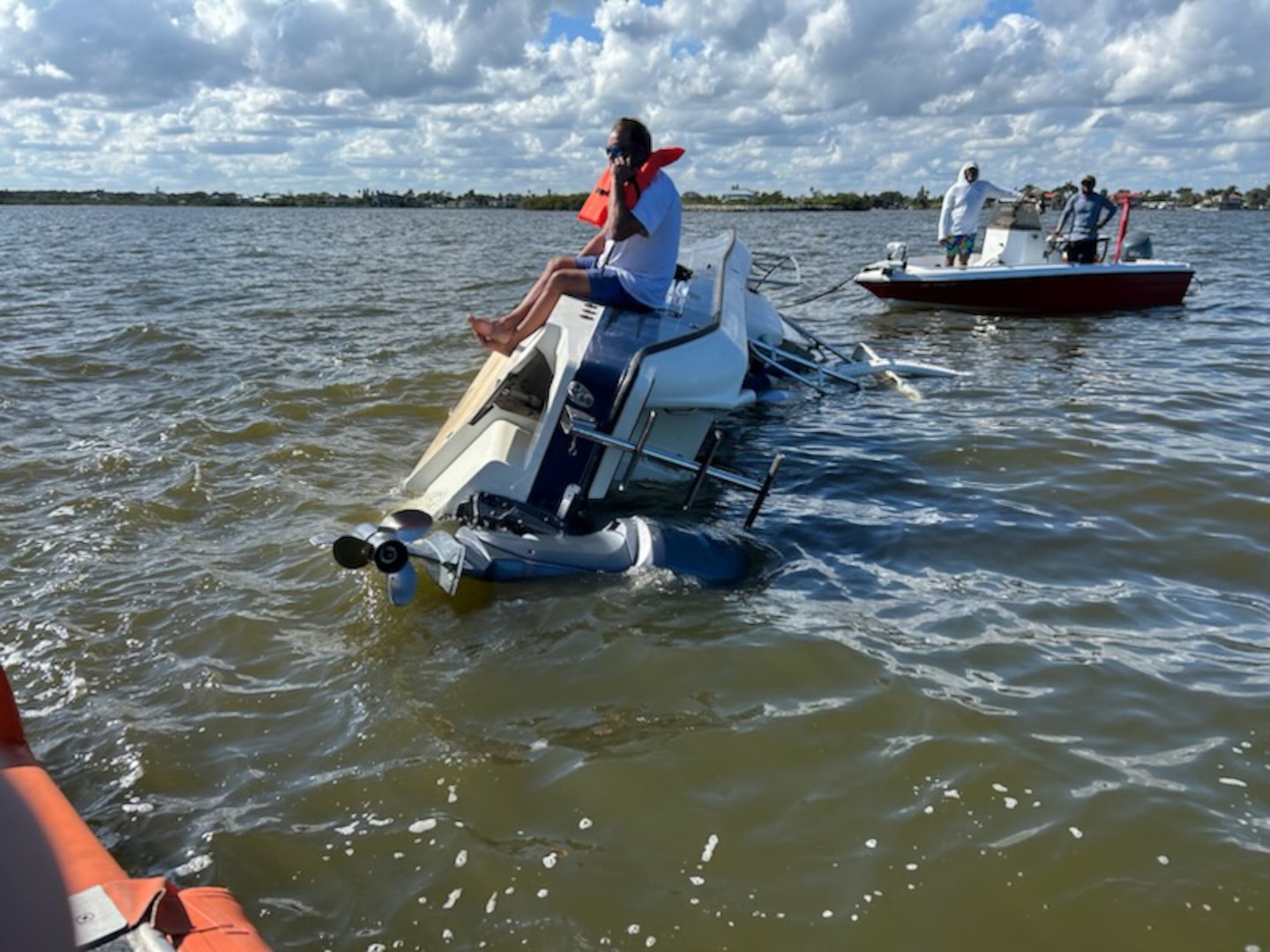 A Coast Guard Station Port Canaveral boat crew rescues a person after their 24-foot vessel capsized on the Banana River near Kelly Park in Port Canaveral, Florida, Jan. 10, 2026.