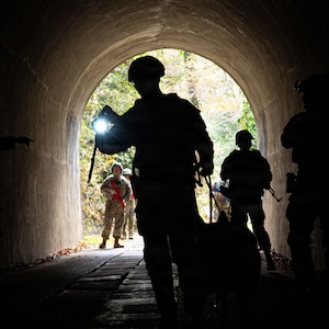 Servicemembers traverse a tunnel