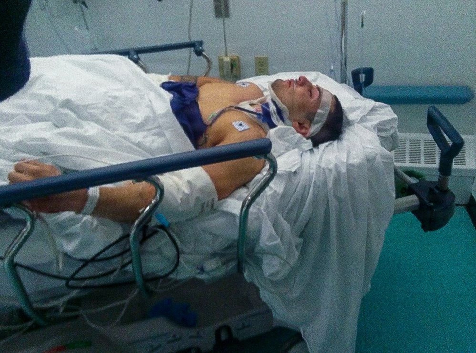 An Airman is prepared for surgery after life-threatening injury.