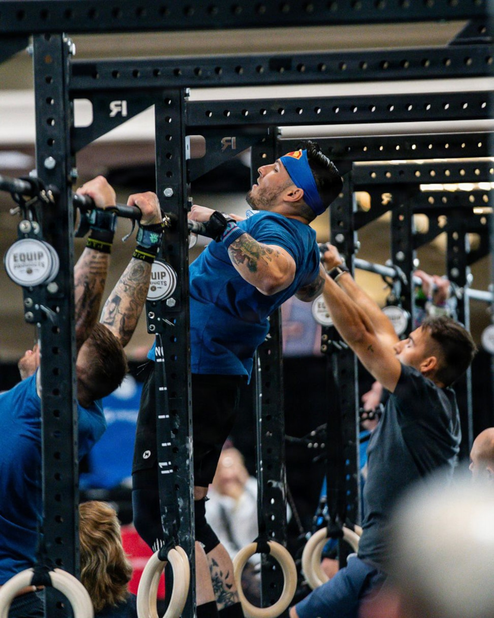 An Airman does pull-ups during a competition.