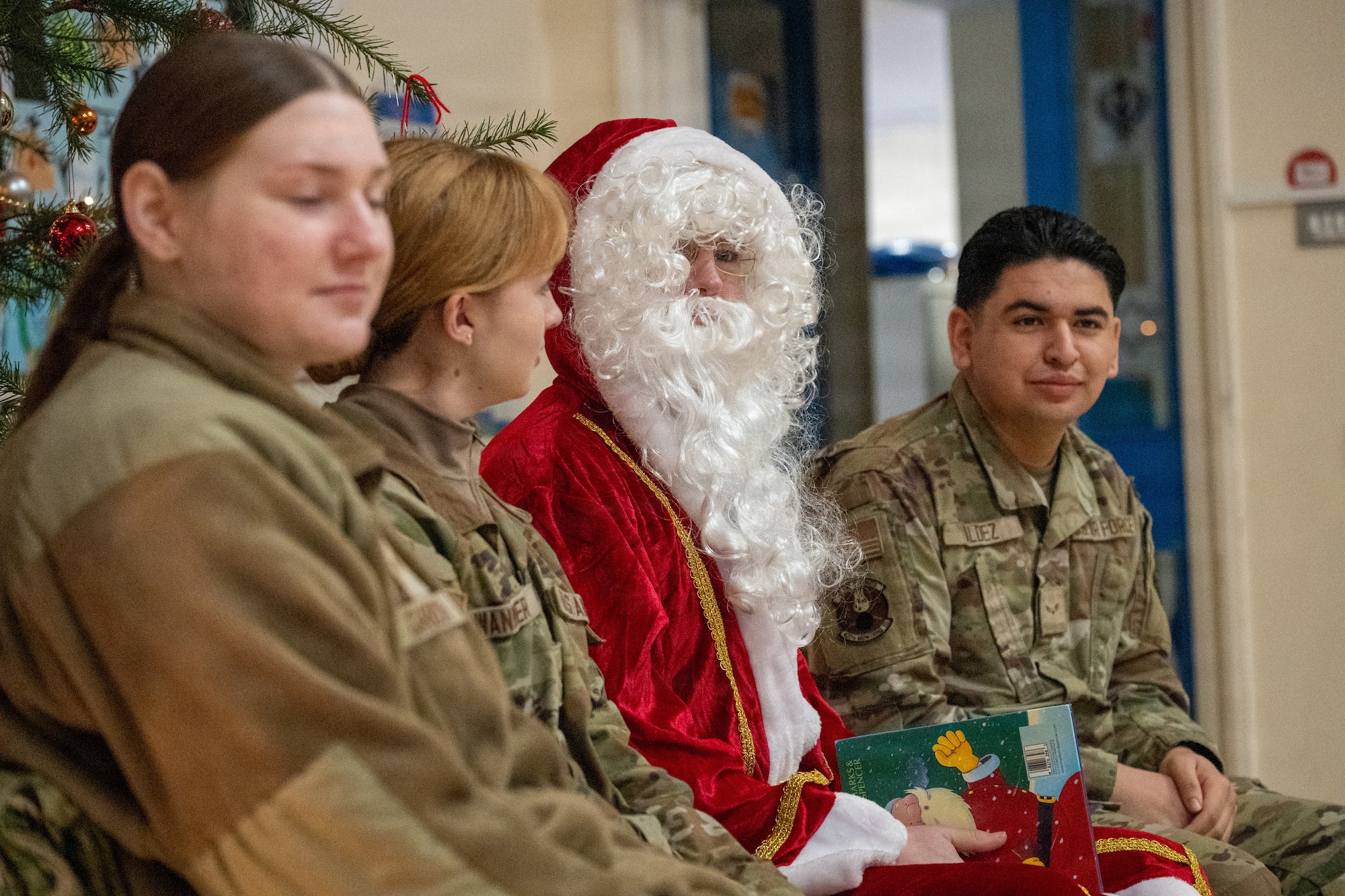 Santa Claus and his helpers assigned to the 420th Munitions Squadron speak with children