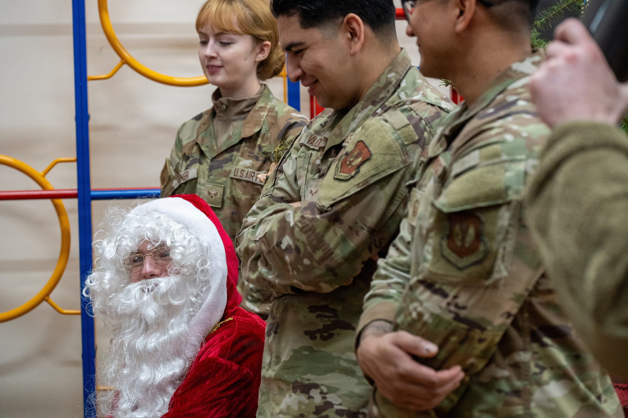 Santa Claus and his helpers assigned to the 420th Munitions Squadron (MUNS) speak with children