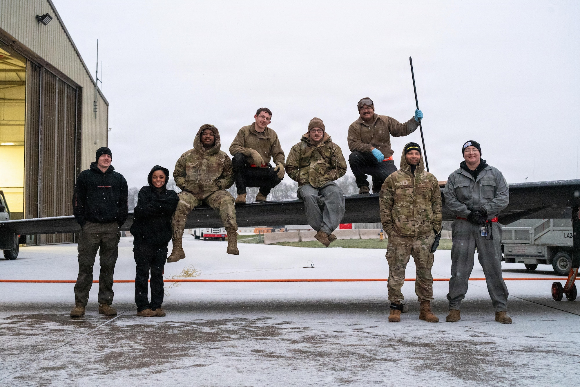 Members of the 99th Expeditionary Reconnaissance Squadron pose on the wing of a U-2 Dragon Lady aircraft