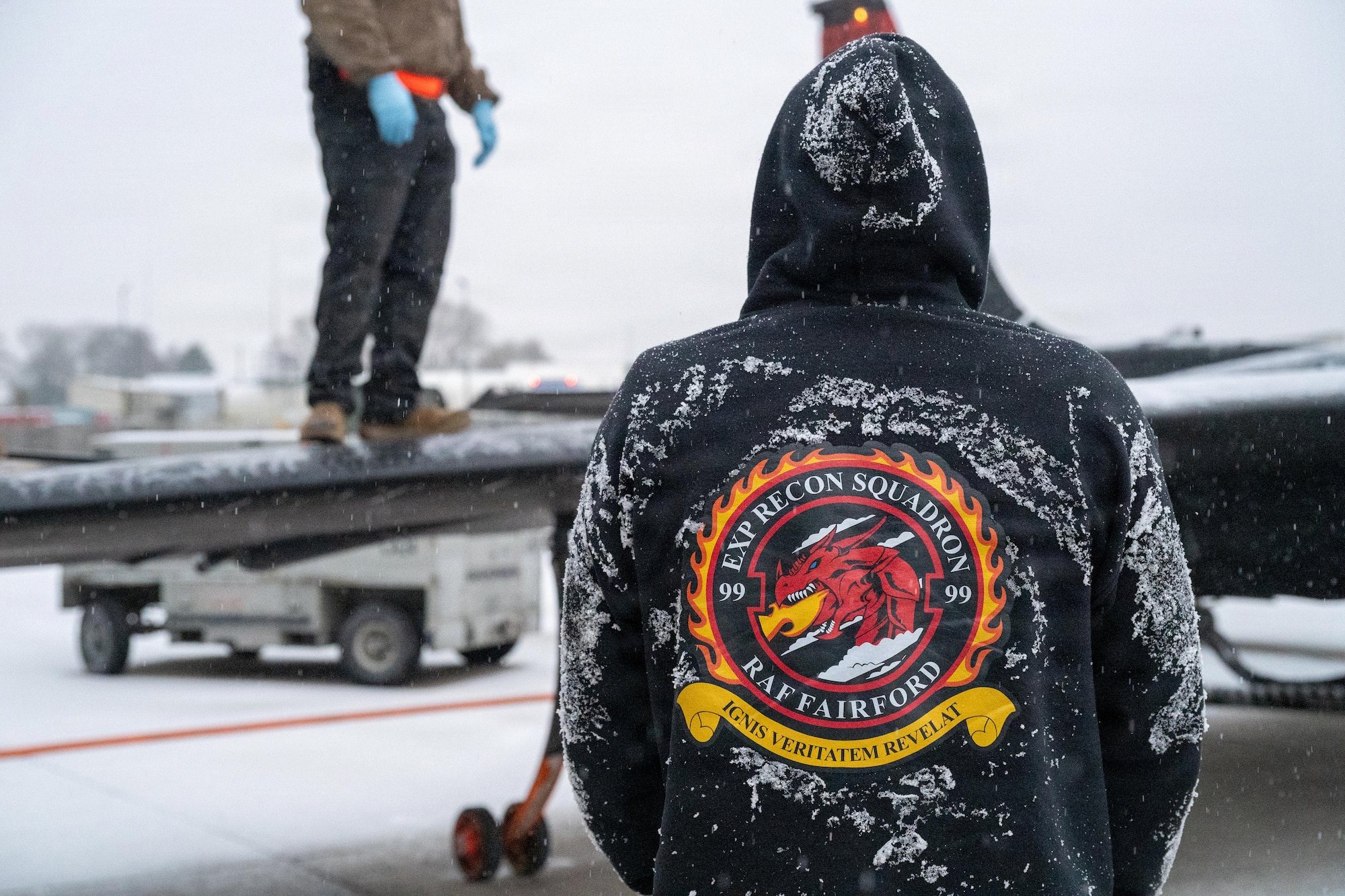 A member of the 99th Expeditionary Reconnaissance Squadron stands near a U-2 Dragon Lady aircraft during ground operations