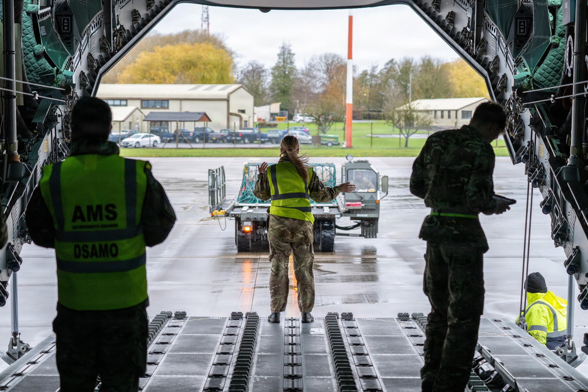 U.S. Air Force and Royal Air Force airmen guide cargo during Project MACE