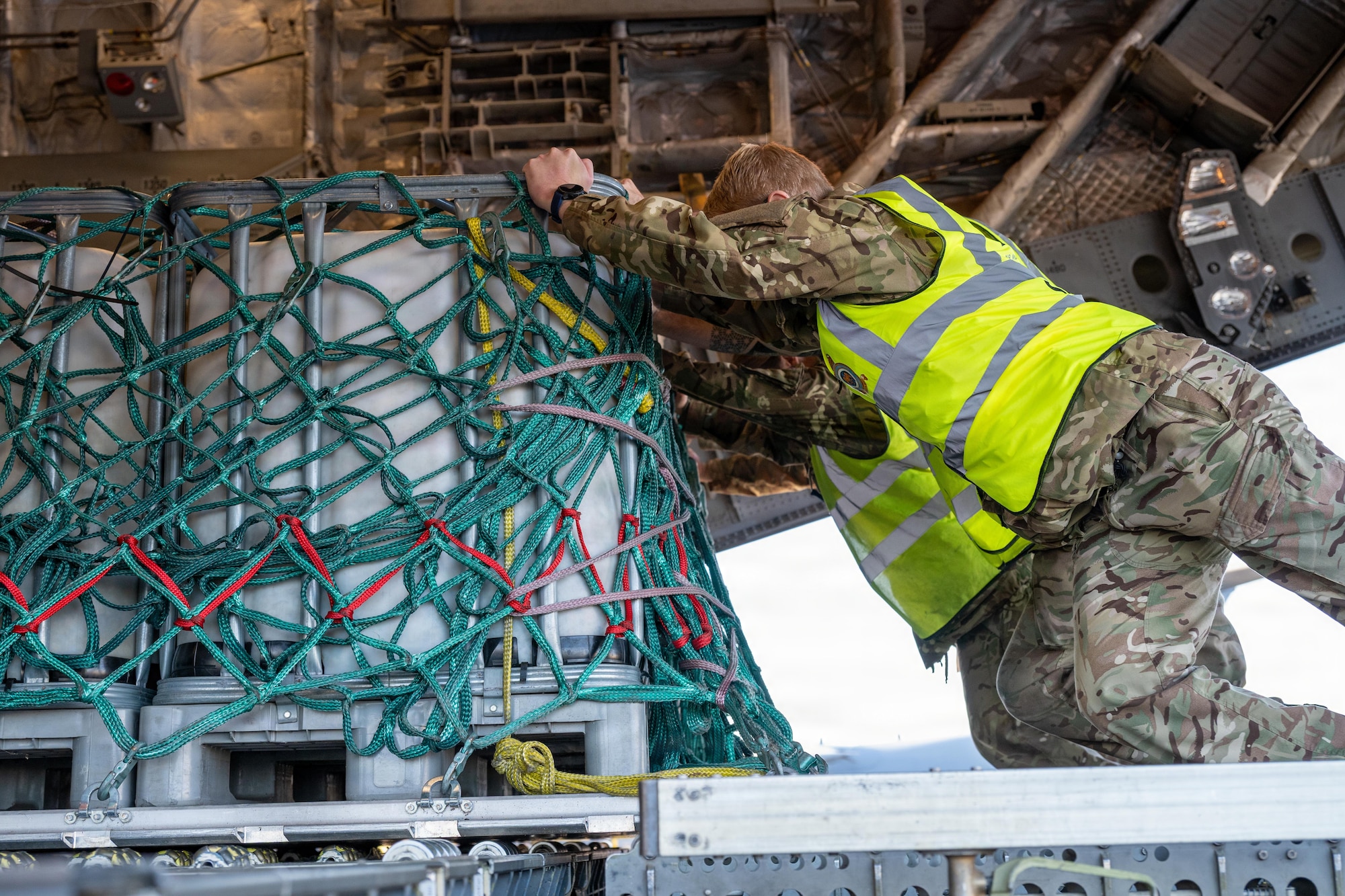 Royal Air Force airmen secure cargo aboard a RAF C-17 Globemaster III