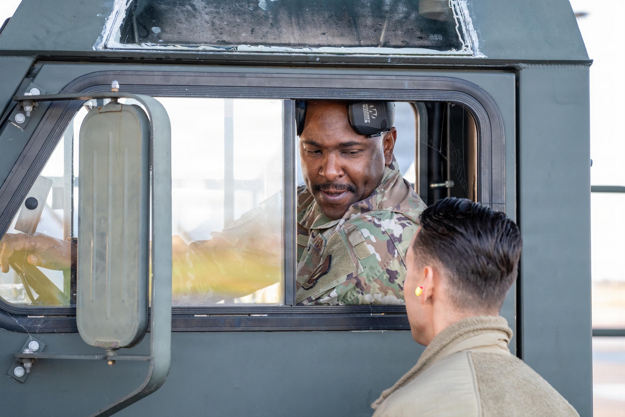 U.S. Air Force Master Sgt. Justin George, 420th Air Base Squadron air operations manager, speaks with Master Sgt. Michael Barbato, 420th ABS logistics readiness flight chief, during ground operations