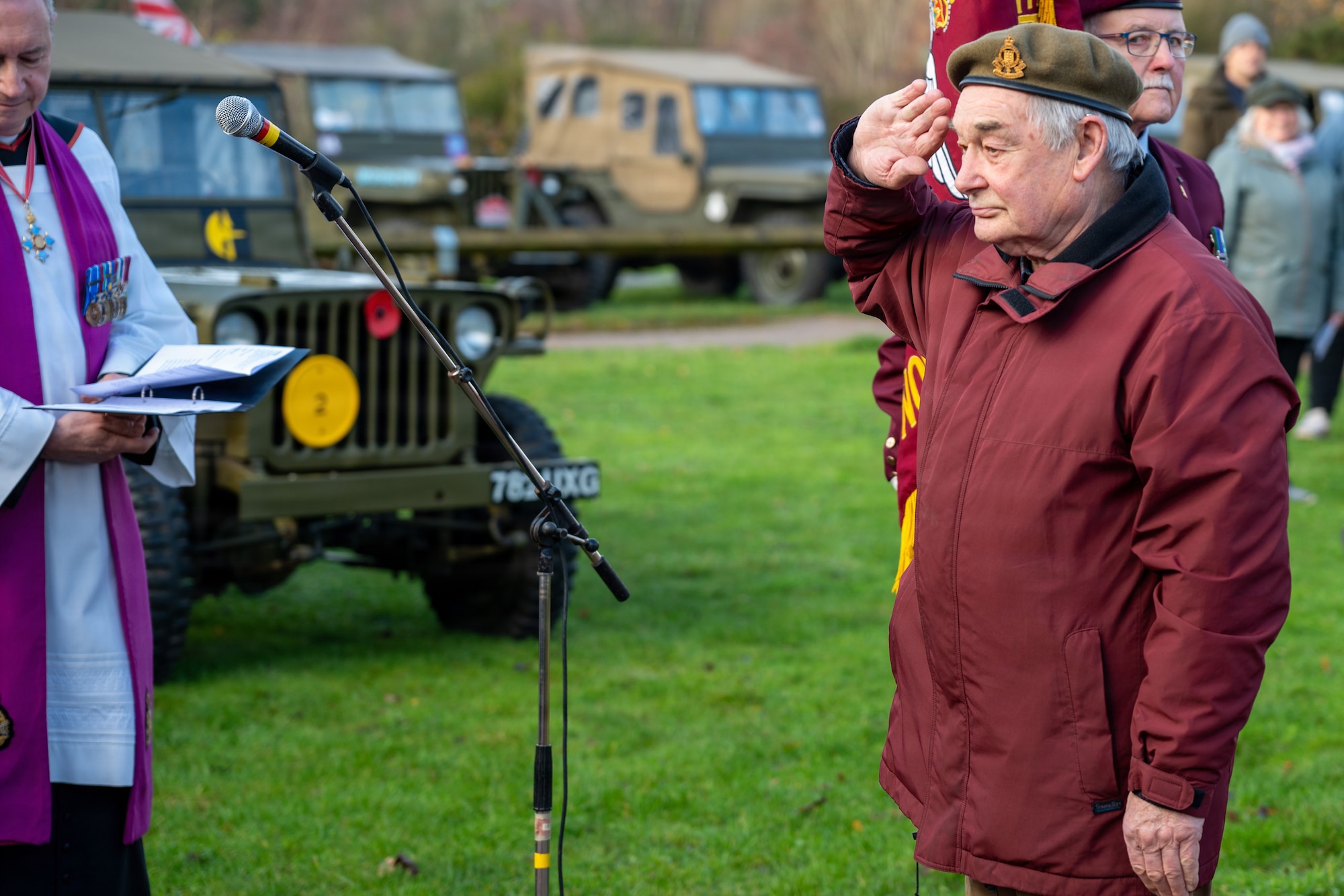 A Royal British Legion member renders a salute during a memorial service