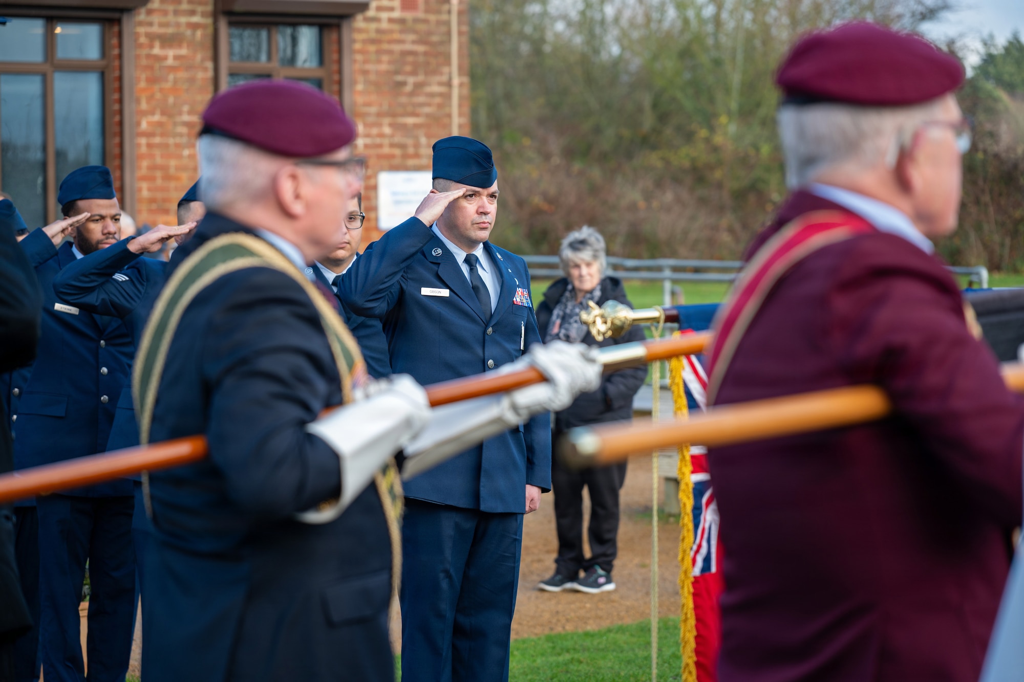 U.S. Air Force Airmen assigned to the 420th Munitions Squadron render salutes during a memorial service
