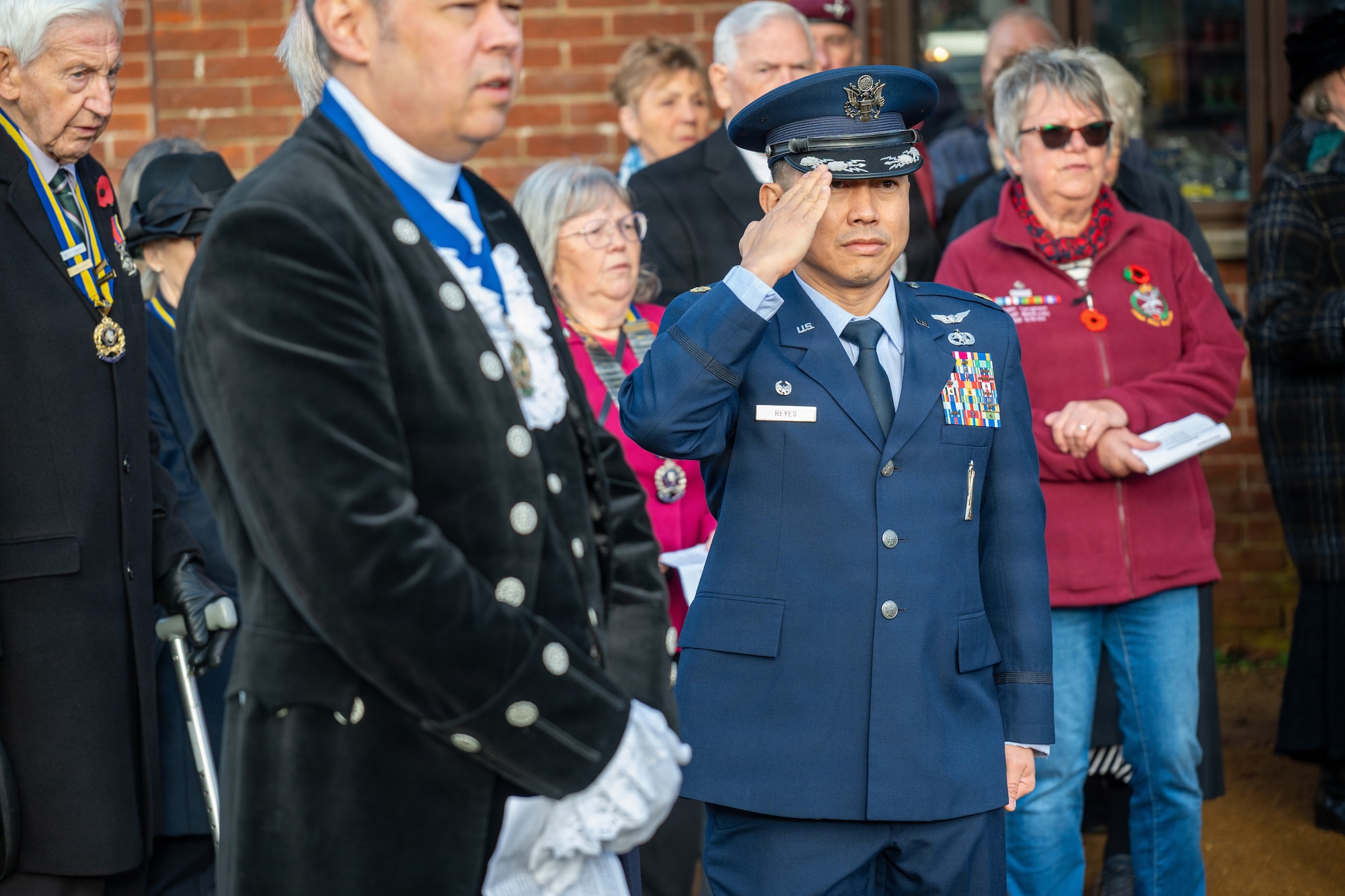 U.S. Air Force Maj. Marques L. Reyes, 420th Munitions Squadron commander, renders a salute during a memorial service