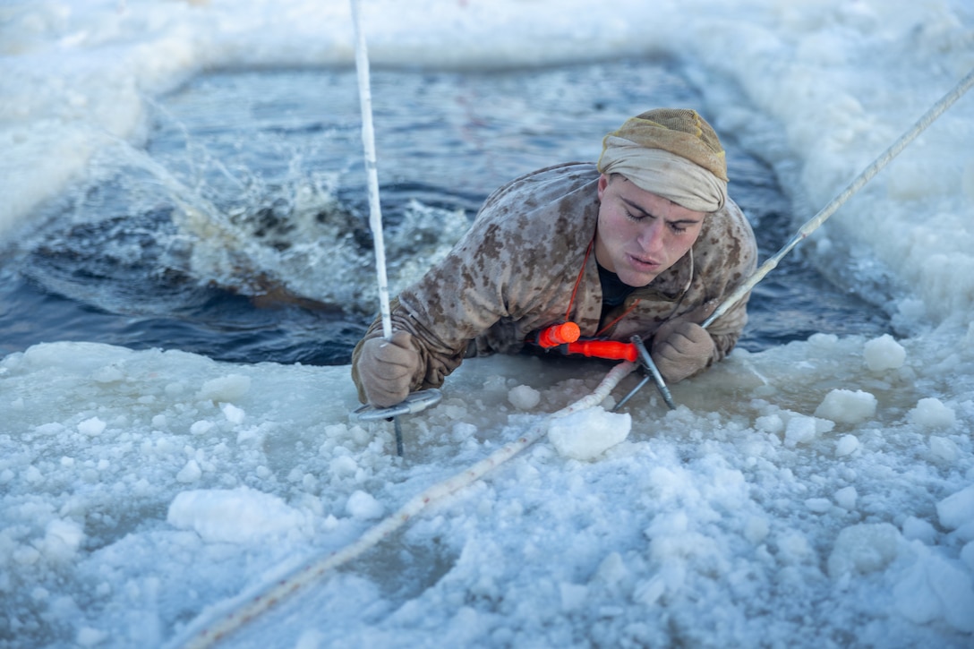 U.S. Marine Corps Sgt. Garret Weimer, a force reconnaissance Marine with 2nd Force Reconnaissance Company, 2nd Reconnaissance Battalion, 2nd Marine Division, climbs out of the water while conducting a cold-water exercise during Winter Warfare Course in Kalix, Sweden, Jan. 7, 2026. The purpose of WWC is to train ground forces in a variety of cold-weather subjects, including skiing, how to use pulk sleds, develop winter fighting positions, camouflage and concealment, and several other areas that are vital in order to survive and operate in a cold-weather environment. It was also conducted in preparation for exercise Cold Response 26.(U.S. Marine Corps photo by Lance Cpl. Hunter J. Kuester)
