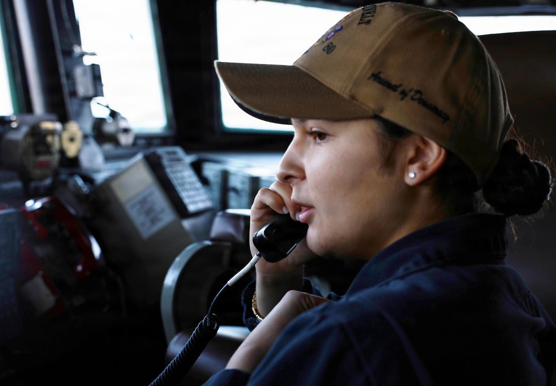 ARABIAN GULF (Jan. 11, 2026) U.S. Navy Ensign Gabrielle Grandjean, assigned to the Arleigh Burke-class guided-missile destroyer USS Roosevelt (DDG 80), receives officer-of-the-deck watch training in the pilothouse during a transit in the Arabian Gulf. Roosevelt is deployed to the U.S. 5th Fleet area of operations to support maritime security and stability in the U.S. Central Command area of responsibility. (U.S. Navy photo by Mass Communication Specialist 1st Class Indra Beaufort)