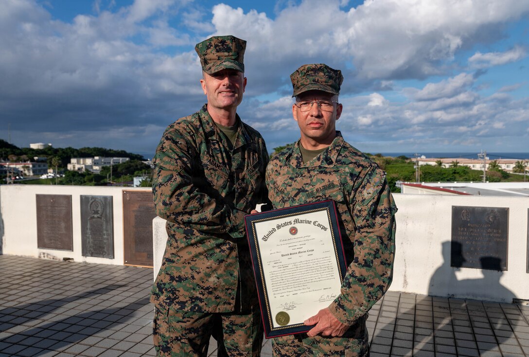 U.S. Marine Corps Sgt. Maj. Christopher Adams, sergeant major of III Marine Expeditionary Force, poses for a photo with 1st Sgt. Christopher McCullar during McCullar’s redesignation ceremony on Camp Foster, Okinawa, Japan, Jan. 9, 2026. McCullar was selected for a lateral move from master sergeant to first sergeant under the new E-8 transfer pilot initiative. McCullar will take over as the senior enlisted advisor for Communications Company, 3rd Marine Littoral Regiment, 3rd Marine Division. (U.S. Marine Corps photo by Cpl. Jeremiah Barksdale)