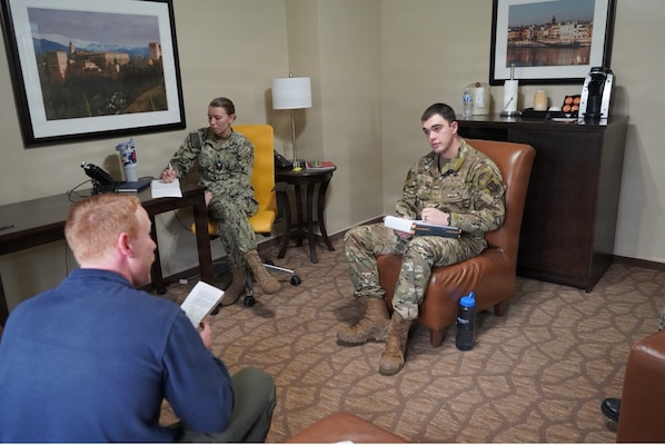 251210-N-FT324-2015. ROTA, Spain (December 10, 2025) – Recovered service members participate in a guided discussion as part of a Survival, Evasion, Resistance and Escape Phase II reintegration exercise conducted as a joint effort between operational and medical teams. SERE training prepares members to survive isolation, resist exploitation, and safely return to friendly control.  For medical staff, the exercise focused on supporting recovery, communication, and readiness following simulated isolation events. (U.S. Navy Photo Taken by Lt. Cmdr. Alicia Sacks)