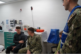 251210-N-FT324-5623. ROTA, Spain (December 10, 2025) – Medical and operational team members conduct a medical assessment during a Survival, Evasion, Resistance and Escape Phase II reintegration exercise at U.S. Naval Hospital Rota. SERE training prepares members to survive isolation, resist exploitation, and safely return to friendly control. The exercise strengthens medical readiness and ensures teams are prepared to support recovered service members during real-world recovery operations. (U.S. Navy Photo Taken by Lt. Cmdr. Alicia Sacks)