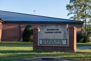 Exterior of a building with a sign in focus.