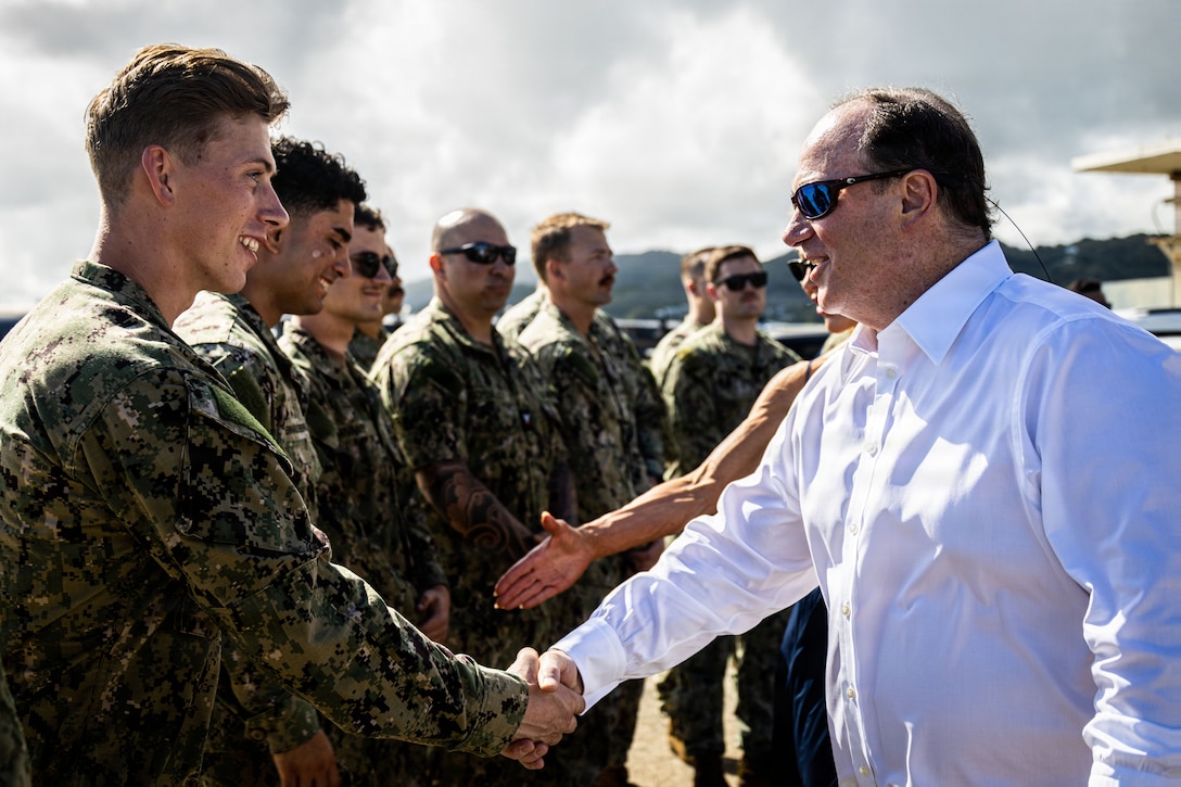 The Honorable John C. Phelan, secretary of the Navy, greets U.S. Sailors with Electronic Attack Squadron (VAQ) 132 at Jose Aponte de la Torre Airport Ceiba, Puerto Rico, Dec. 24, 2025. U.S. military forces are deployed to the Caribbean in support of the U.S. Southern Command mission, Department of War-directed operations and the president’s priorities to disrupt illicit drug trafficking and protect the homeland. (U.S. Marine Corps photo)