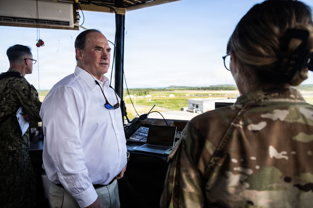 The Honorable John C. Phelan, secretary of the Navy, speaks with an air traffic controller from the 346th Air Expeditionary Wing, at Jose Aponte de la Torre Airport Ceiba, Puerto Rico, Dec. 24, 2025. U.S. military forces are deployed to the Caribbean in support of the U.S. Southern Command mission, Department of War-directed operations and the president’s priorities to disrupt illicit drug trafficking and protect the homeland. (U.S. Marine Corps photo)