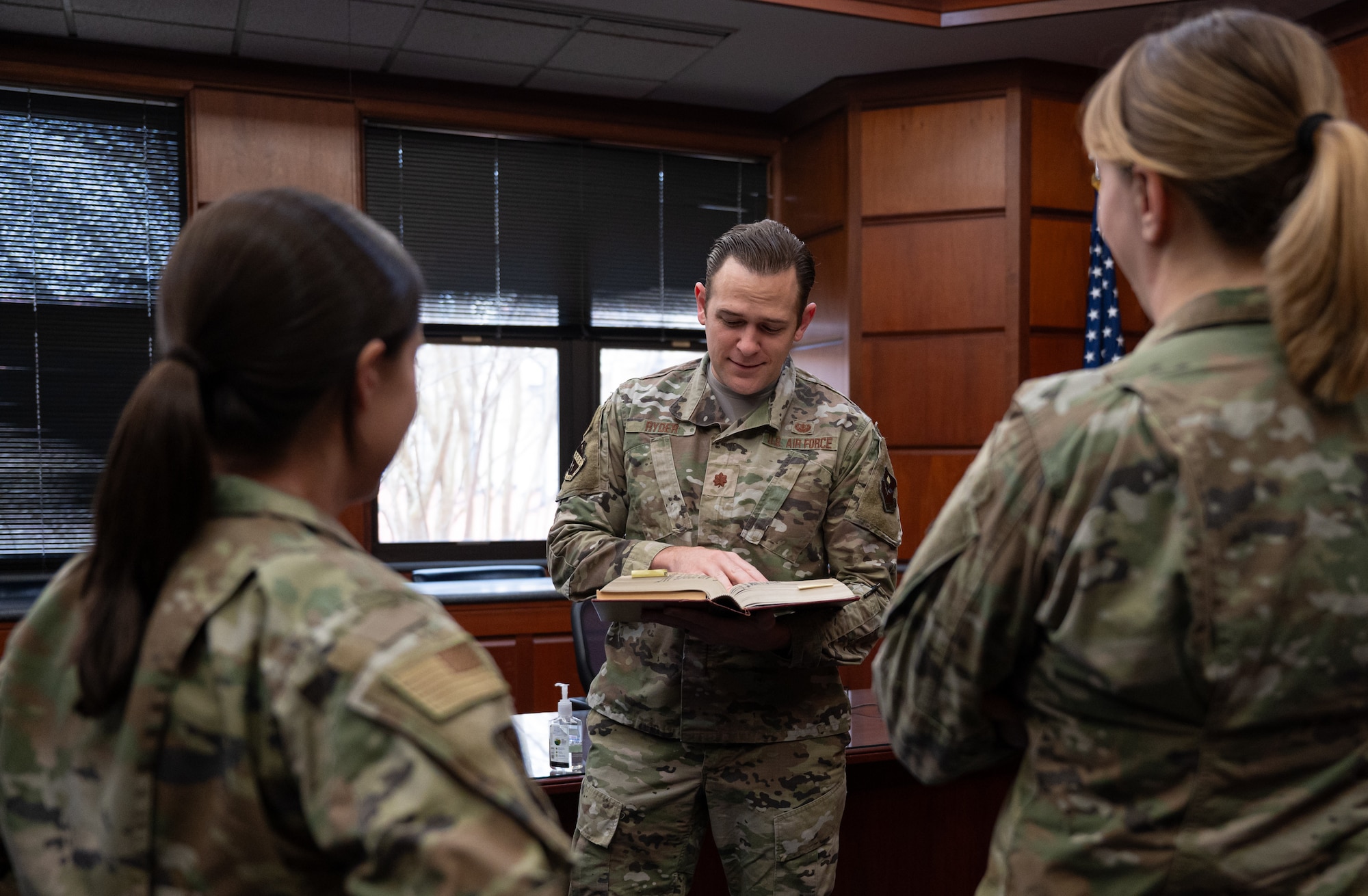 Maj. Stephan Ryder, center, General Corps deputy staff, provides legal clarification to Capt. Abbigale Harris, left, chief of military justice, and Tech. Sgt. Leslie Frederick, noncommission officer in charge of the justice section, all assigned to the 42d Air Base Wing Judge Advocate office, at Maxwell Air Force Base, Alabama, Dec. 06, 2026.